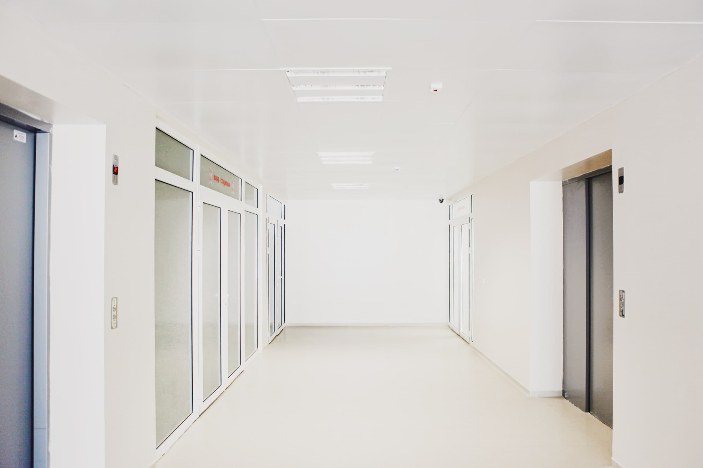 Bright hospital corridor with glass doors