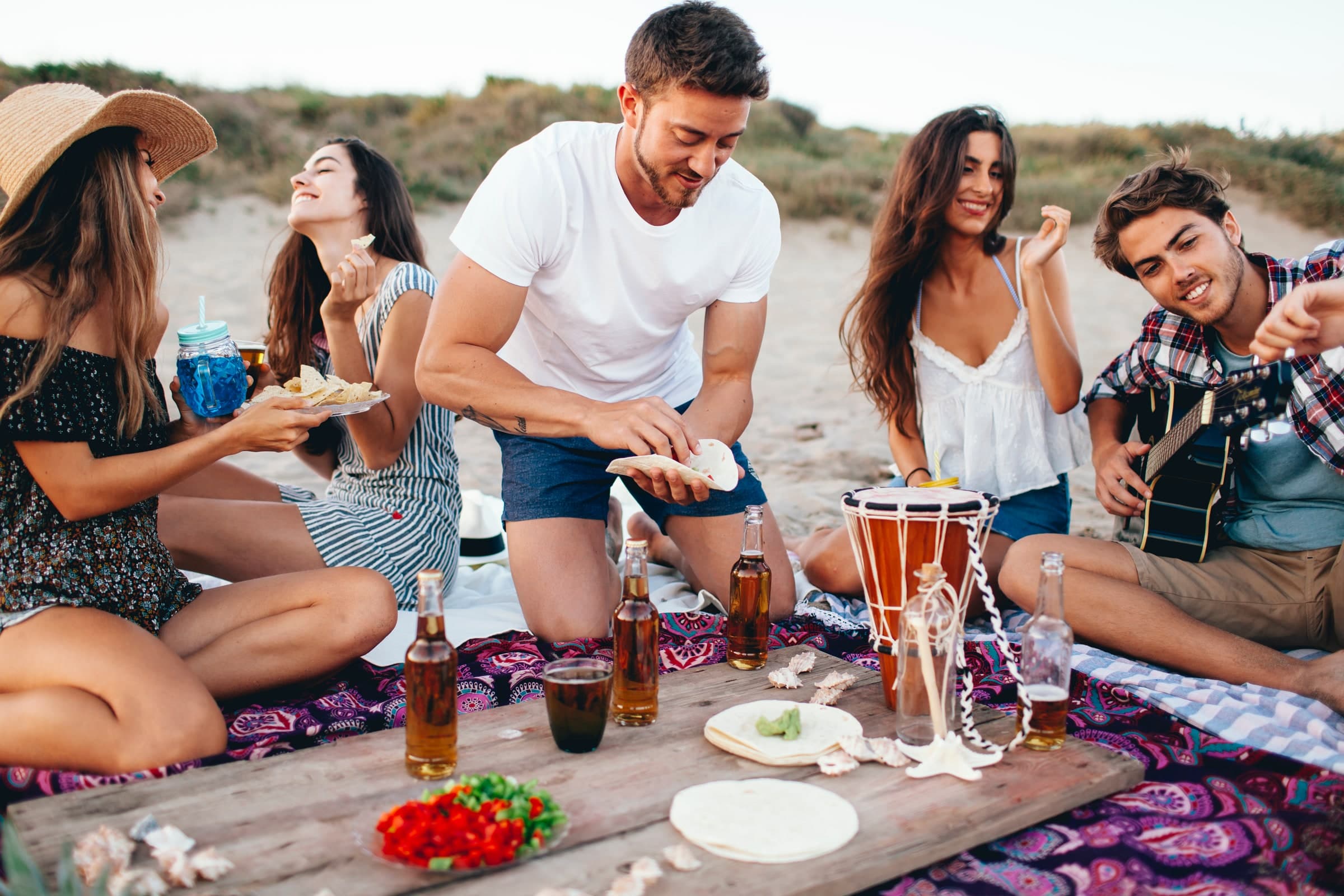Friends sharing a picnic on the beach