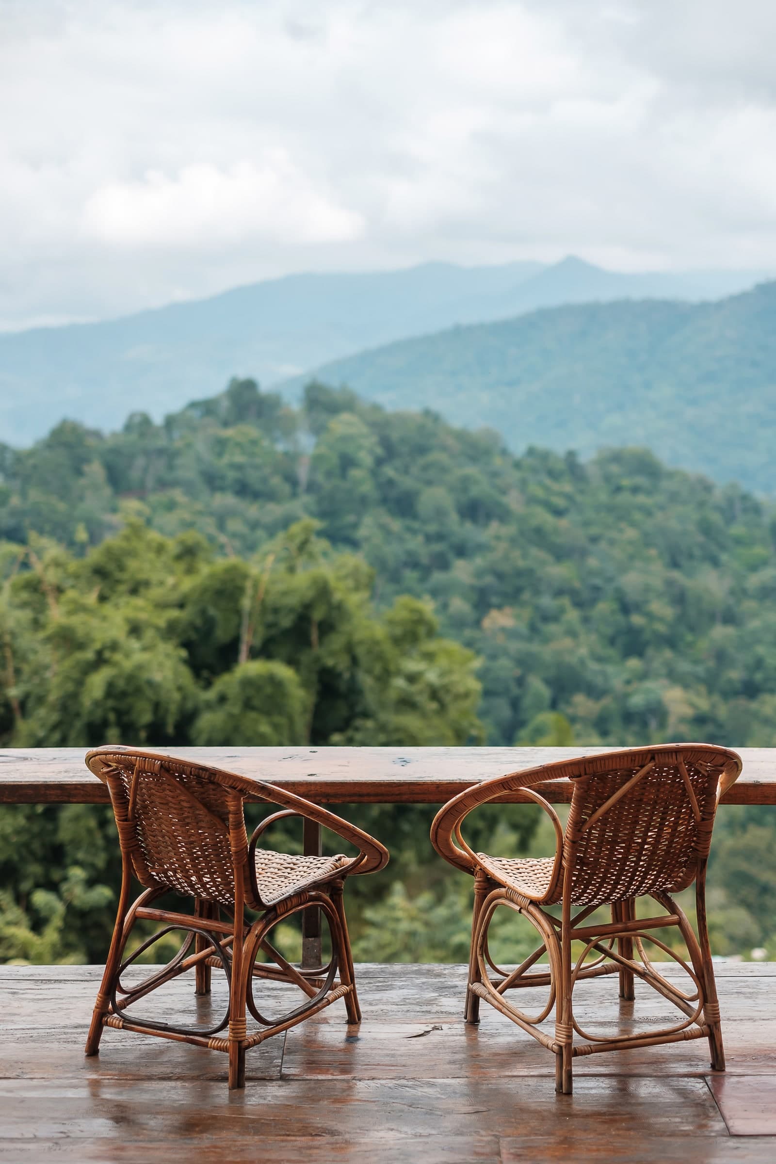 Chairs on a balcony overlooking green hills
