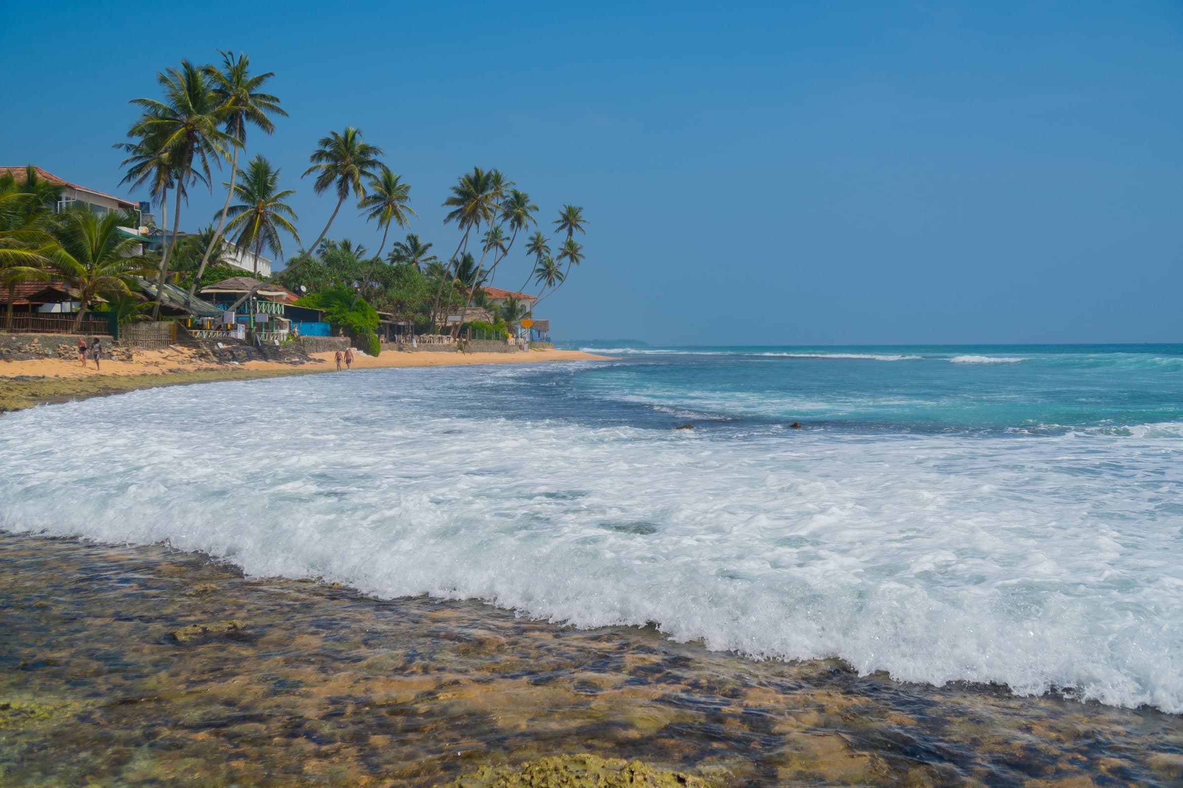Waves along the palm-lined beach at Hikkaduwa